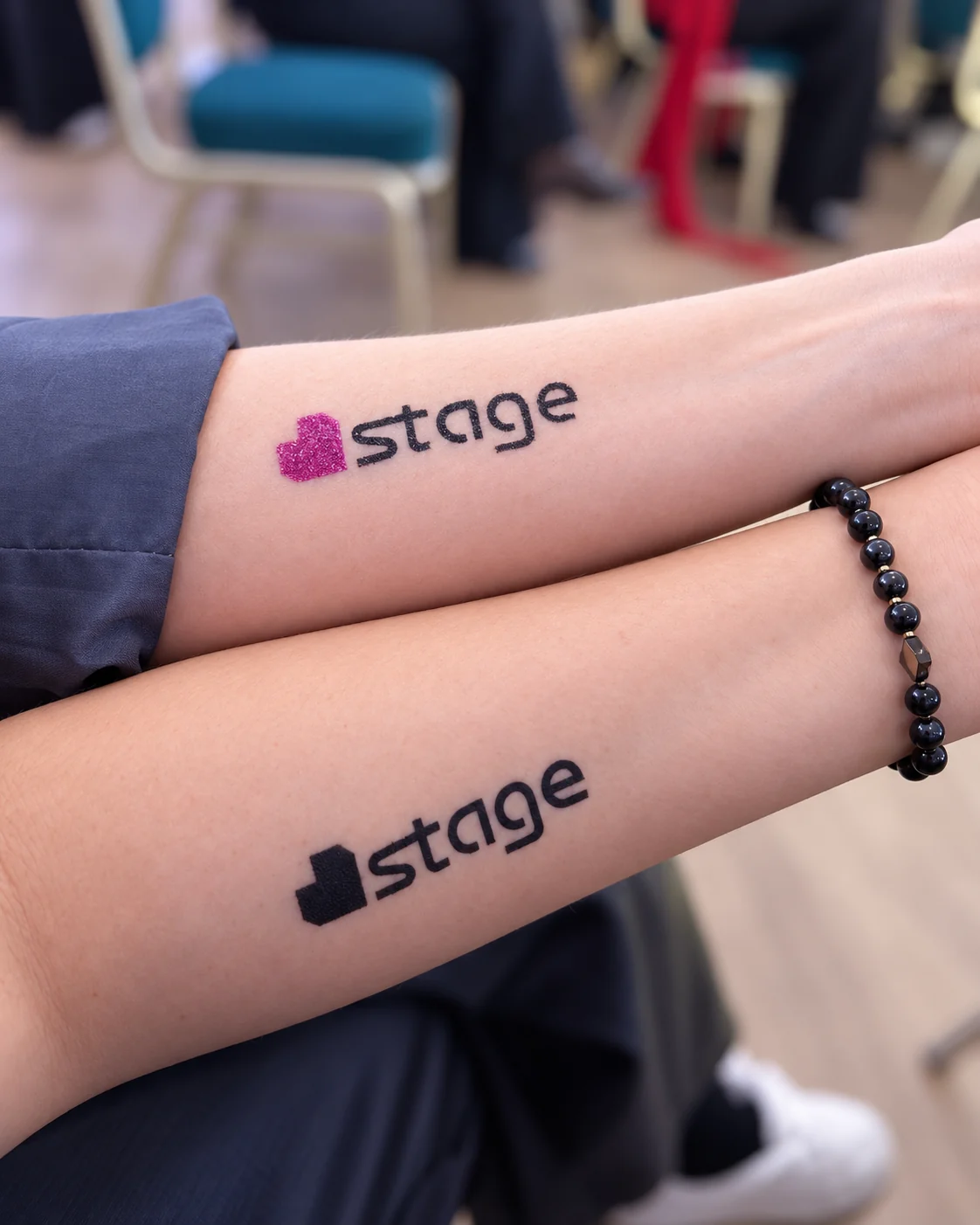 Temporary tattoos of the Stage logo on participants' arms